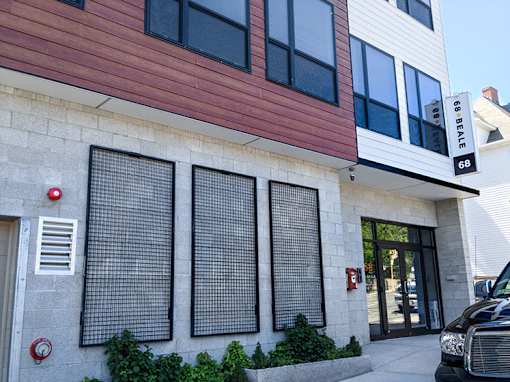 Contemporary building facade with mixed siding materials at 68 Beale Apartments, Massachusetts